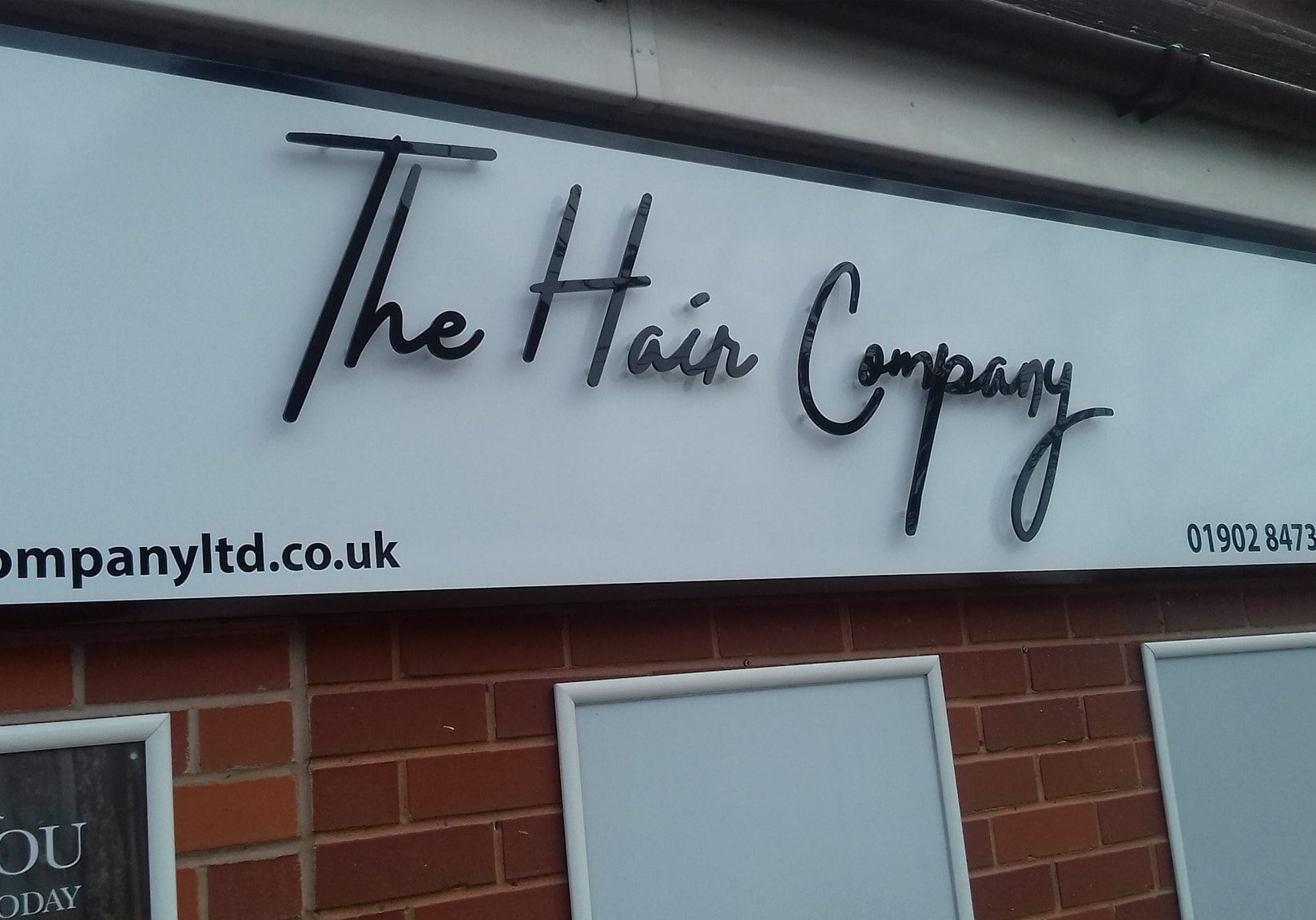 The Hair Company salon sign